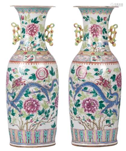 A pair of Chinese famille rose vases, decorated with dragons and flower branches, 19thC, H 60,5 cm (damage)