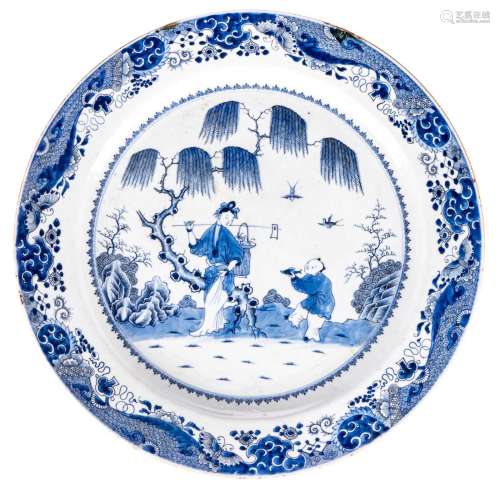 A large Chinese blue and white plate, decorated with figures in a garden, 18thC - Qianlong, D 55,5 cm (damage)