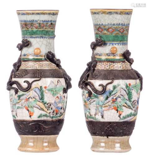 Two Chinese polychrome stoneware baluster shaped vases, relief decorated with dragons and a flaming pearl, overall decorated with a warrior scene, marked, about 1900, H 30,5 cm