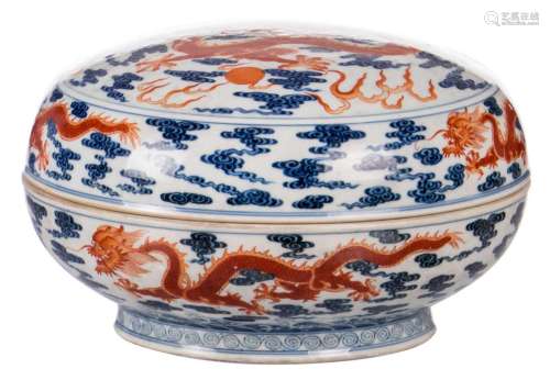 A Chinese polychrome box with cover, depicting dragons chasing the flaming pearl among clouds, marked Qianlong, H 14,5 cm - Diameter 23,5 cm