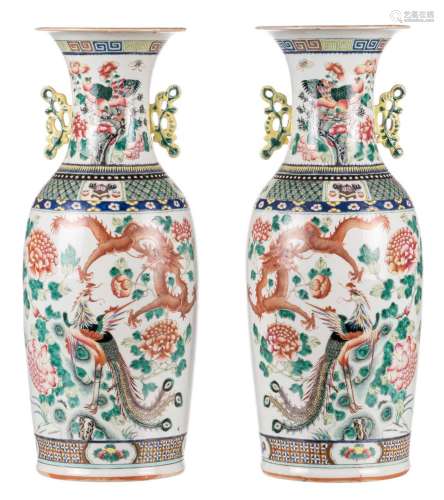 A pair of Chinese famille rose vases, one side decorated with a dragon, a phoenix, birds and flower branches; the other side with antiquities, flower branches and fruits, H 60 cm