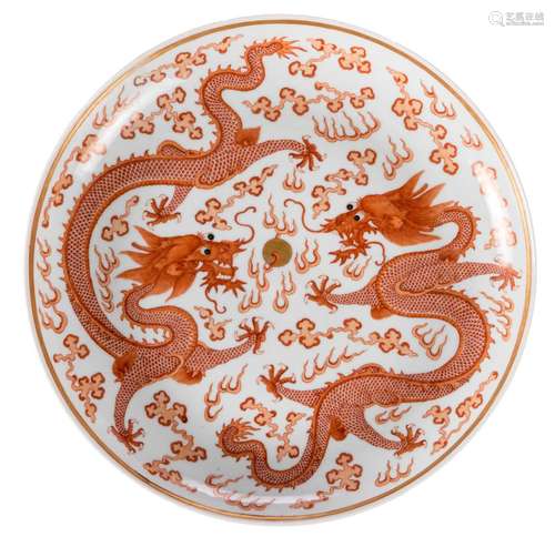 A Chinese iron red and gilt decorated plate, with dragons and flaming pearls, with a Qianlong mark, Diameter 34 cm