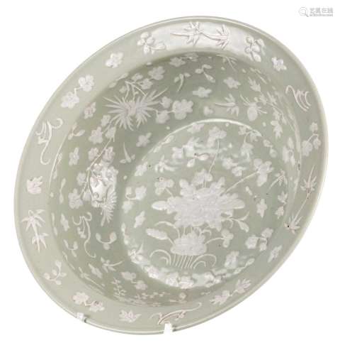 A Chinese celadon groud floral relief decorated bowl, 19thC, H 12,5 - Diameter 41 cm