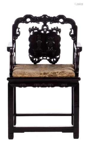 A Chinese hardwood carved armchair with a matching cushion, about 1900, H 98 cm