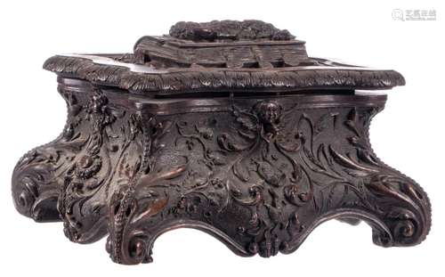 A sculpted walnut jewelry box decorated with religious symbols, H 16 - W 32 - D 26 cm