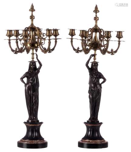 A pair of patinated and gilt bronze Neoclassical candlesticks on a marble base, late 19th-early 20thC, H 72 cm