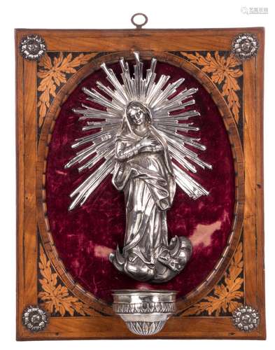 A silver holy water font, depicting Our Lady of the Crescent, in a cherrywood frame, inner holy water font in tin, possibly Eastern Europe, 24 x 30 cm