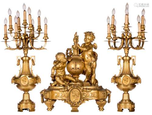 An impressive French Neoclassical gilt bronze three-piece garniture, decorated with putti, 19thC, H 72 (clock) - 102 cm (candlesticks)