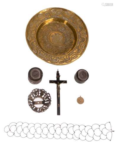 A lot with a brass offering dish, (17thC); a silver Madonna crown; a crucifix, bronze and ebony wood, (17thC); a medal mold with print and a strap belt