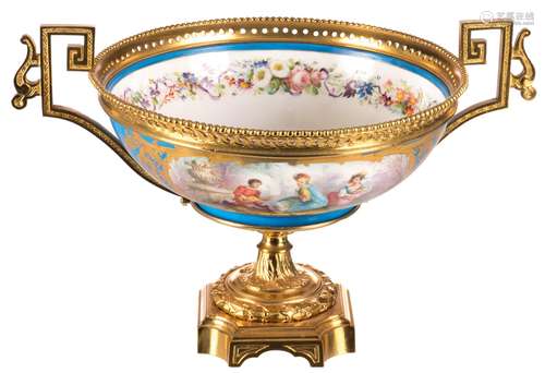 A polychrome decorated porcelain centre bowl, bleu céleste ground and the roundels painted with animated scenes in the Boucher manner, gilt bronze mounts, with a blue overglaze Sèvres mark, H 26 - Diameter bowl 28,5 cm