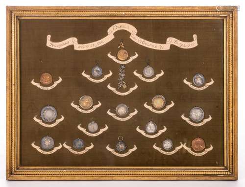 A framed colllection of various silver/silver plated/gold plated medals won by students of the Franciscus Xaverian School during stenograph contests, late 19thC, 59 x 78 cm