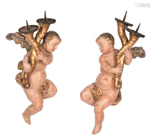 A pair of polychrome painted wooden chandeliers depicting torch-bearing angels, possibly German, 17th/18thC, H 52 cm