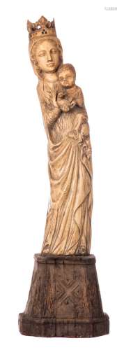 Our Lady and child and pigeon, patinated ivory on a wooden Gothic revival base, probably workshop Heckman Paris, early 20thC, H 60,5 (without base) - 79,5 cm (with base) - Total weight about 8300g