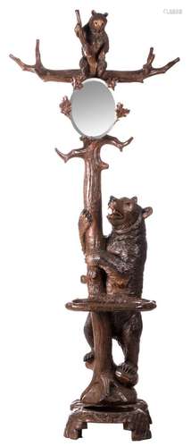 A sculpted limewood coat tree in the Black Forest manner, depicting a bear with her cub, with an oval mirror held in place by some branches, H 202 cm