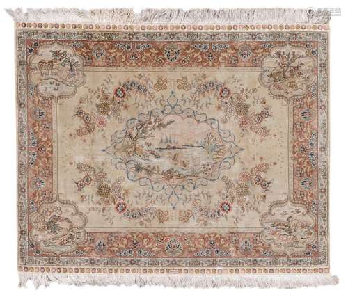 An Oriental silk rug with floral motifs, the roundels with animals, marked, 97,5 x 123,5 cm