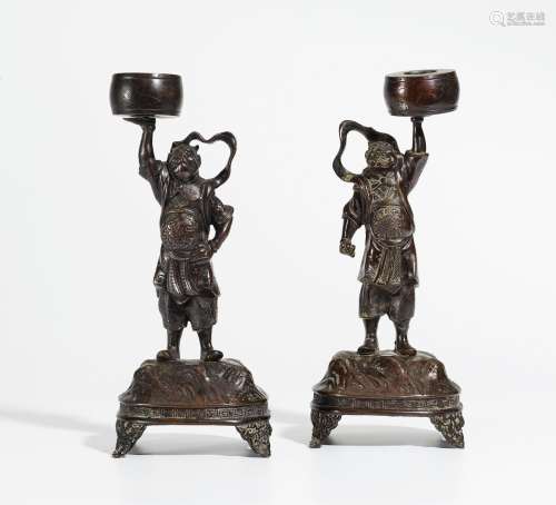 PAIR CANDLEHOLDER IN THE SHAPE OF MYTHICAL GUARDS WITH DRUMS.