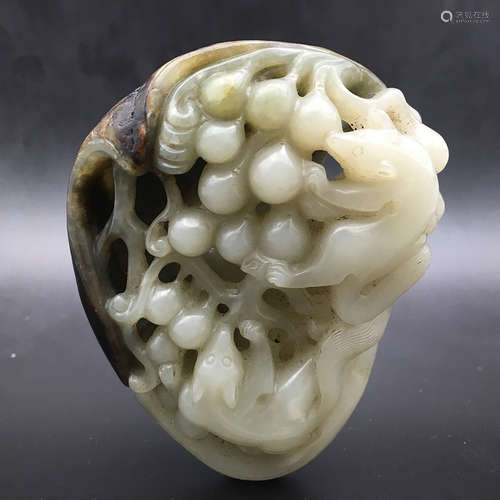 A CHINESE WHITE AND RUSSET JADE SQUIRREL AND GRAPE