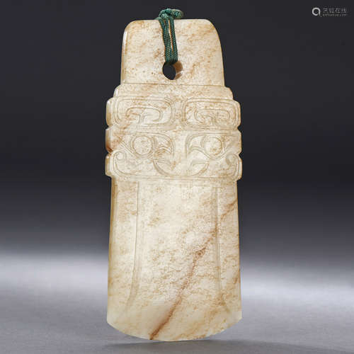 A CHINESE WHITE AND RUSSET JADE CARVING OF AN AXE