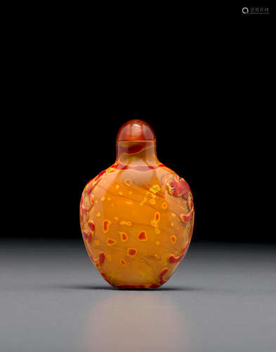 Probably Imperial, attributed to the Palace Workshops, Beijing, 1740-1800 A carved 'realgar' glass snuff bottle