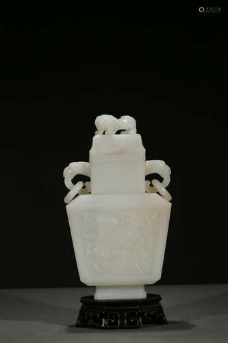 A white jade carved 'buddhist lion' vase