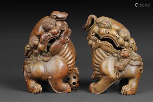 A pair of bamboo root buddhist Lions carvings