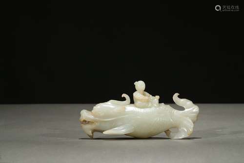 A white jade 'boy upon dragon-carp' carving