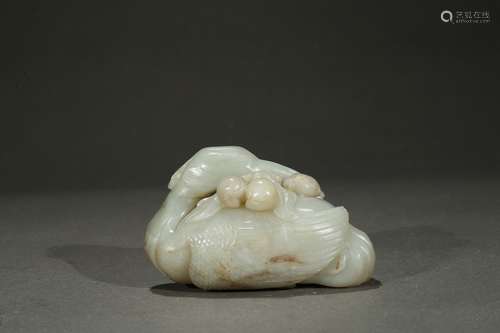 A white jade 'crane and peach' carving