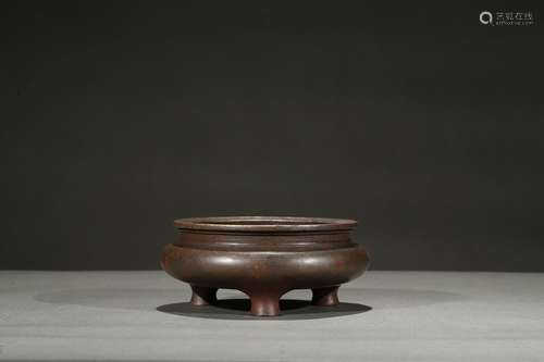 A bronze compressed tripod censer