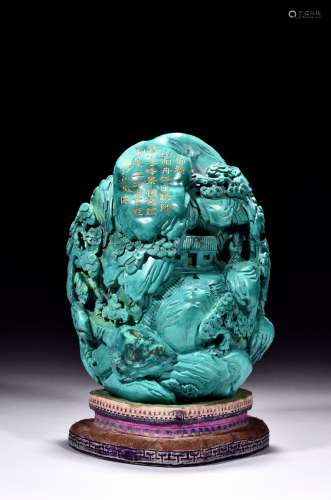 A turquoise carved 'deep mountain' boulder