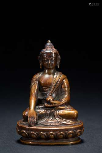 A small bronze figure of seated Shakyamuni