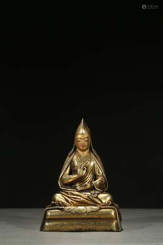 A gilt-bronze figure of Lama