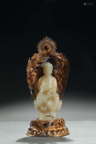 A white jade buddha with gilt filigree stand