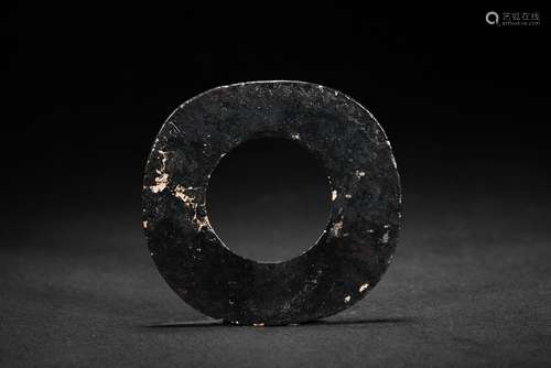 A dark opaque jade carved disc