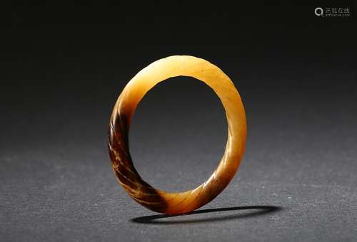 An archaic mottled jade twisted-rope bangle