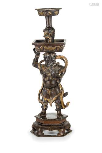 A PARTIALLY GILT BRONZE FIGURE CANDLESTICK, CHINA, 17TH CENTURY