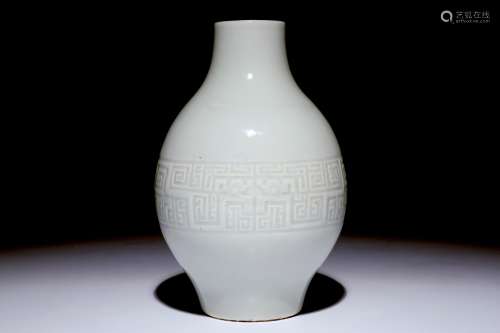 A Chinese monochrome white-glazed olive-shaped vase with underglaze design, Qianlong mark,  19th C.