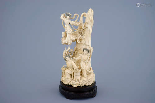 A Chinese carved ivory group of the moon goddess and two girls on a wooden base, 19/20th C.