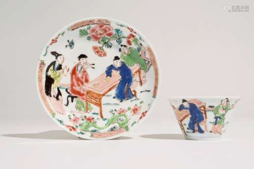 A Chinese famille rose cup and saucer with a tea-drinking scene, Yongzheng