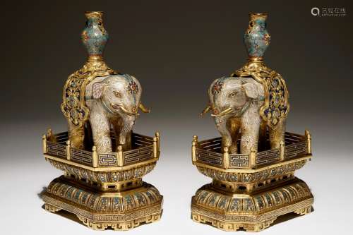 A pair of Chinese glit bronze and cloisonne elephants on stands, 19th C.