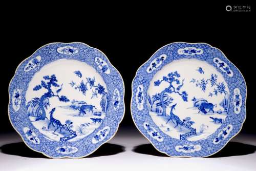 A pair of Chinese blue and white plates with animals in a garden, Qianlong