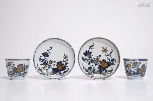 A pair of Chinese blue, white and gilt cups and saucers, Qianlong