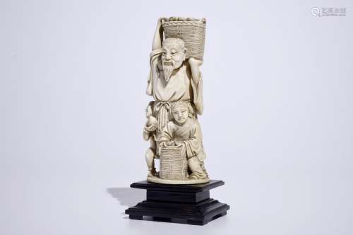 A Chinese ivory group of a peach picker on wooden base, early 20th C.