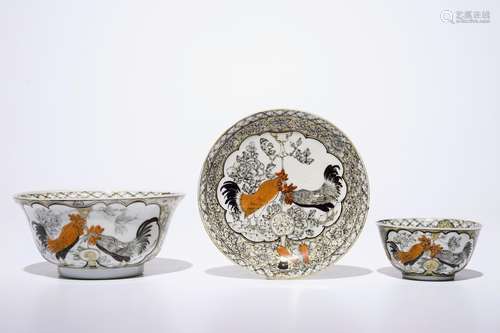 A Chinese grisaille, gilt and iron-red bowl with matching cup and saucer with roosters, Yongzheng