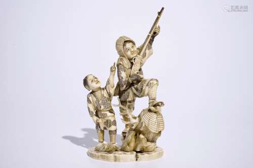A Japanese ivory okimono of a hunter and his son, Meiji, late 19th C., signed