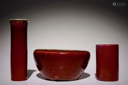 A Chinese monochrome sang-de-boeuf-glazed brush pot, a beaker vase and a bowl, 19/20th C.