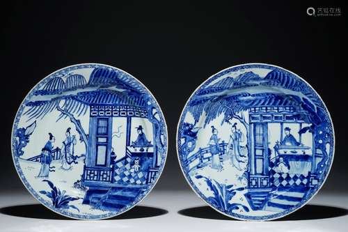 A pair of Chinese blue and white chargers with a scene from 