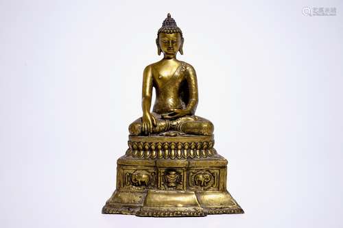 A gilt bronze model of Buddha seated on a throne, Nepal or Tibet, 19/20th C.