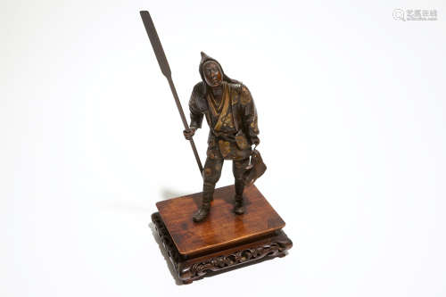 A Japanese bronze figure of a fisherman, signed Miyao, on a wooden stand