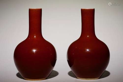 A pair of small Chinese monochrome copper red tianqiu ping bottle vases, 19/20th C.