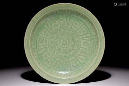 A Chinese celadon dish with incised lotus design, 19th C.